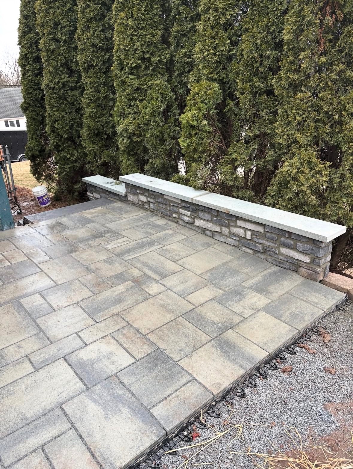 Paver patio with capped stone retaining wall