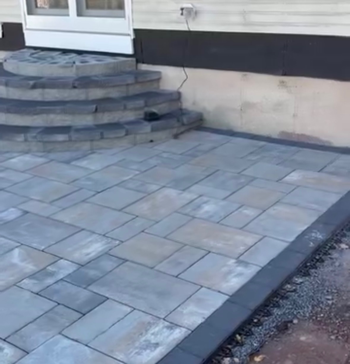 Paver patio with curved masonry steps